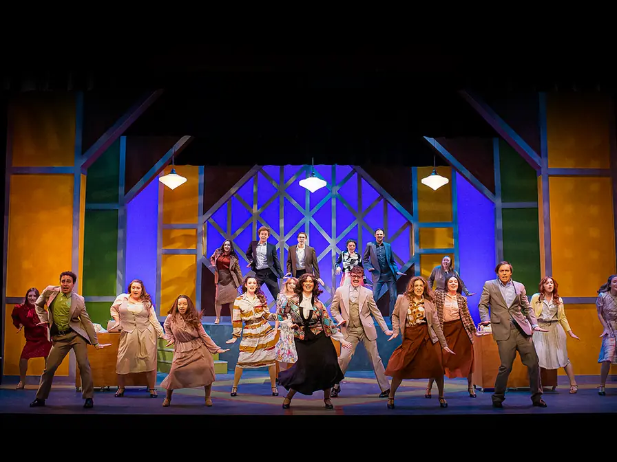 Production photo from 9 to 5 showing Gretchen Ugalde's office-world scenic design for Stephens College.