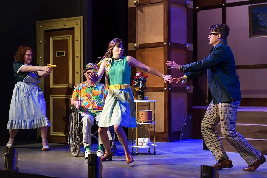 Production photo from Lucky Stiff showing Gretchen Ugalde's playful scenic design for Maples Repertory Theatre.